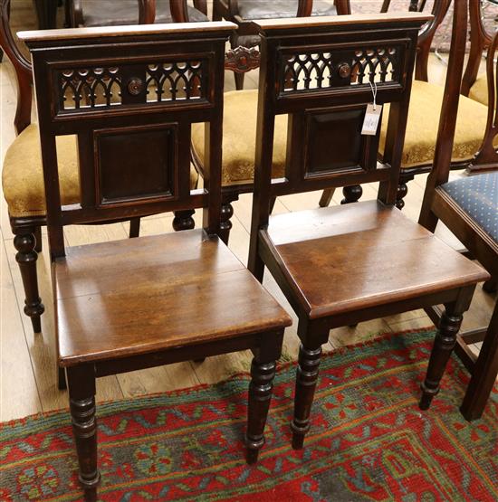 A pair of late Victorian mahogany hall chairs
